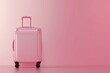 © Your Choice - Pink luggage standing against a light pink background in a minimalist setting