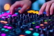 © Jane_S - Close-up of a DJ's hands adjusting controls on a soundboard, surrounded by colorful neon lights.