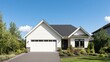 © Pemika - Modern house with a garage and landscaped yard, blue sky in the background.