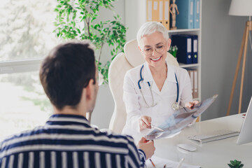 Sticker - Photo of aged woman qualified doctor show x-ray patient man wear white coat workplace office indoors