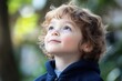 © kiewkoii - Joyful child looking up with wonder