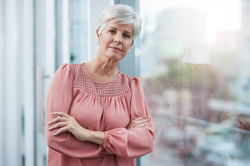 Portrait, business and old woman with arms crossed, window and confidence with career ambition. Face, pensioner and elderly lady in modern office, view and pride with startup, calm and entrepreneur