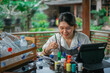 © Odua Images - asian woman making handmade craft from plastic bottle waste and painting them