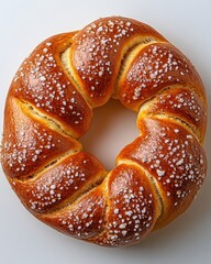 Wall Mural - A single soft pretzel with coarse salt on its glossy brown surface, isolated on white background 