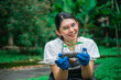 © Odua Images - asian woman planting seedling using recycle plastic bottle waste, recycle and reuse concept