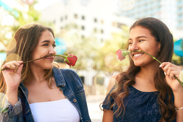 Girl friends, rose and smile for adventure, travel and bonding together in Miami park. Comic, joke and women with playful, happy and outdoor on vacation relax for urban summer holiday or weekend