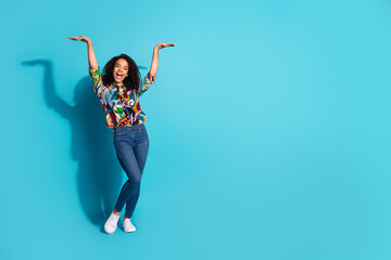 Wall Mural - Photo of pretty lovely cheerful woman wear stylish clothes hold empty space poster isolated on blue color background