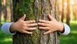 © Abele - nature lover close up of child hands hugging tree with copy space