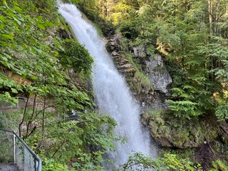 Wall Mural - Giessbach Falls in the eponymous nature park and over Lake Brienz - Giessbachfälle (Giessbachfaelle) im gleichnamigen Naturpark und über dem Brienzersee-Canton of Bern, Switzerland (Schweiz)