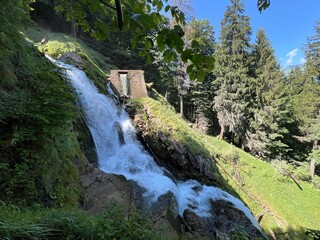 Wall Mural - Giessbach Falls in the eponymous nature park and over Lake Brienz - Giessbachfälle (Giessbachfaelle) im gleichnamigen Naturpark und über dem Brienzersee-Canton of Bern, Switzerland (Schweiz)