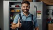 © NoblePix - A smiling appliance repair technician stands in front of a refrigerator in the kitchen and gives a thumbs up after successfully completing the refrigerator repair. Concept of professional home.