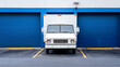 © well - A front view of a delivery truck parked at a loading dock, ready to load goods