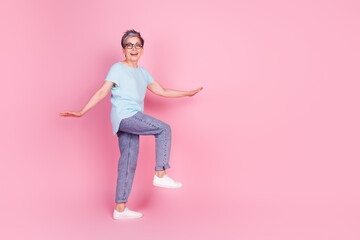 Sticker - Full body profile portrait of nice aged lady walk stairs empty space isolated on pink color background