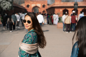 Agra, India, March 23, 2024. Portrait of an Asian woman with the Taj Mahal in the background.