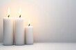 © Guy - Three candles are lit and are on a white background