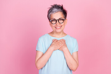 Poster - Photo of nice aged woman arms touch chest blue t-shirt isolated on pink color background