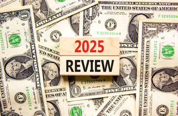 Planning 2025 review new year symbol. Concept words 2025 Review on beautiful wooden blocks. Dollar bills. Beautiful background from dollar bills. Business 2025 review new year concept. Copy space.