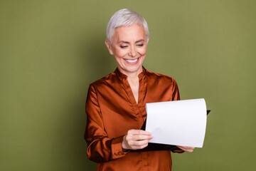 Sticker - Photo of lovely pensioner lady agent read contract dressed stylish brown formalwear isolated on khaki color background