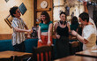 © qunica.com - A lively group of young friends enjoying music and dancing in a warm, inviting cafe atmosphere. Their joyful expressions reflect friendship and celebration.