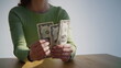 © stockbusters - Woman hands checking amount of cash money at table closeup. Lady counting salary