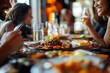 © Shahzad - Friends at a restaurant, sharing lunch and laughter, appetizing food on the table.
