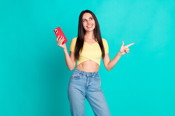 photo of pretty young woman indicate finger empty space wear top isolated on teal color background