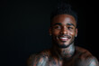© S photographer - African American man has tattoos on his body on black background.