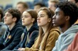© Oleh - Group of high school or university students are listening attentively to a lecture in an auditorium. The diverse group of young adults is engaged and focused on the lesson