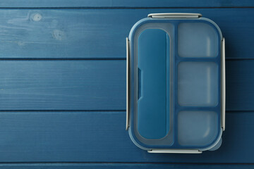 Wall Mural - Empty lunch box on blue wooden table, top view. Space for text