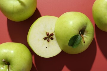 Sticker - Whole and cut apples on red background, flat lay