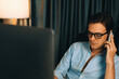 © InfiniteFlow - Smart businessman calling with smartphone for consulting business paragraph dynamic database marketing analysis plan surrounded paper sheet and pc monitor report at home office at night. Pecuniary.