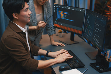 Wall Mural - it developers discussing with point to intelligent website development coder system running data onl