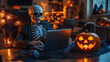 © kwangze - Skeleton in suit working on laptop beside a Halloween pumpkin.