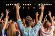 © Mselected - Crowd enjoying a live music concert with raised hands in an evening atmosphere