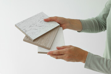 Poster - Woman with samples of wooden flooring indoors, closeup