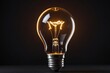© Introvertia - Brightly glowing light bulb against dark background