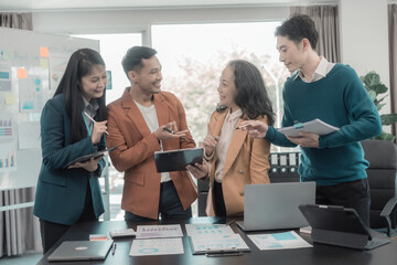 Group of business people discussing charts and graphs displaying business concepts, successful teamwork with investment and business growth showing teamwork results.