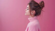 © ChimE - A stunning young woman poses gracefully with a casual bun, exuding confidence and charm against a pink backdrop.