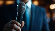© Photock Agency - Confident Businessman Holding Microphone on Stage
