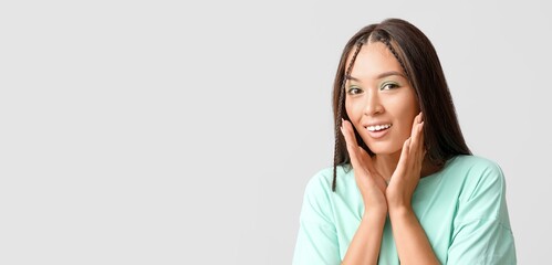 Sticker - Happy young Asian woman with stylish mint makeup on grey background with space for text