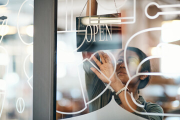 Canvas Print - Business woman, cafe and window with open sign, welcome or ready for service at indoor restaurant. Female person, waitress or employee with poster, billboard or label for startup at coffee shop