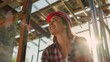 © PUTRI - A Smiling Female Construction Worker Wearing a Hard Hat
