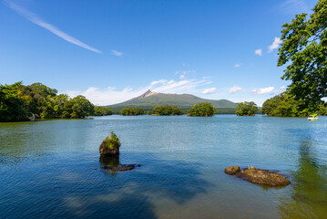 Onuma Quasi-National Park, located in Hokkaido, is a scenic area known for its beautiful lakes and small islands scattered throughout
