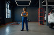 © Nomad_Soul - Full length portrait of man auto mechanic wearing uniform over garage interior