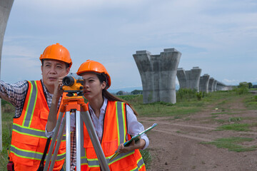 Surveyors working at new construction site. construction worker on a site. Surveyor engineers using an Leveling camera at Construction Site.
