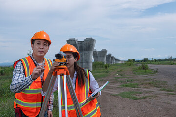 Surveyors working at new construction site. construction worker on a site. Surveyor engineers using an Leveling camera at Construction Site.
