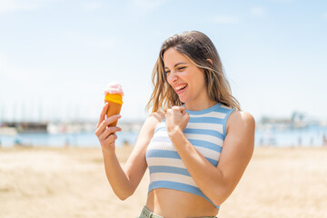 Sticker - Young pretty woman with a cornet ice cream at outdoors celebrating a victory