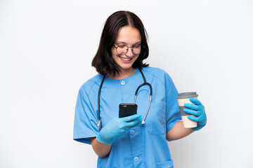 Young nurse caucasian woman isolated on white background holding coffee to take away and a mobile