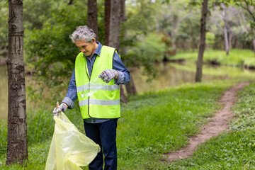 Team volunteer worker group enjoy charitable social work outdoor in cleaning up garbage and waste separation project at the park or natural forest for community service and recycle concept