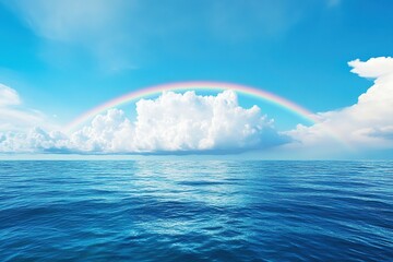 Wall Mural - Rainbow in blue sky over the ocean